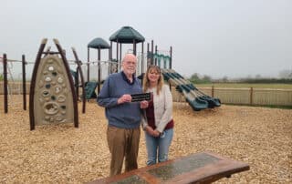 Richard Thom and Heidi Roberts holding plaque