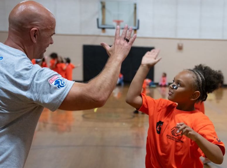 coach and girl high-five