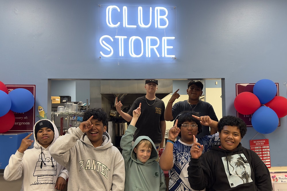 life_workforce_image_4 group of boys standing in front of neon sign