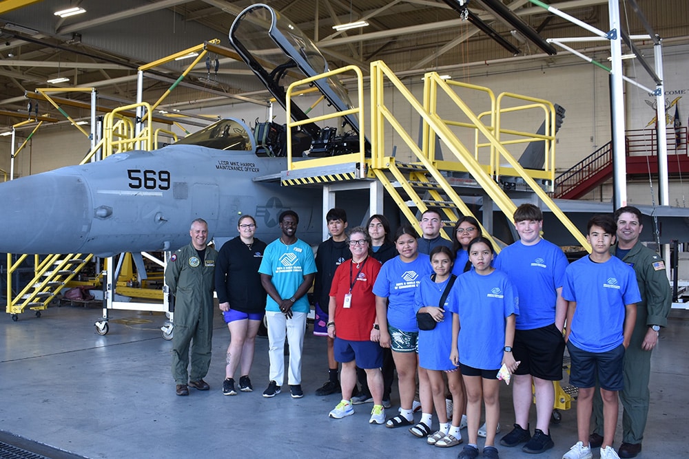 life_workforce_image_5 group of kids and pilot standing beside military aircraft