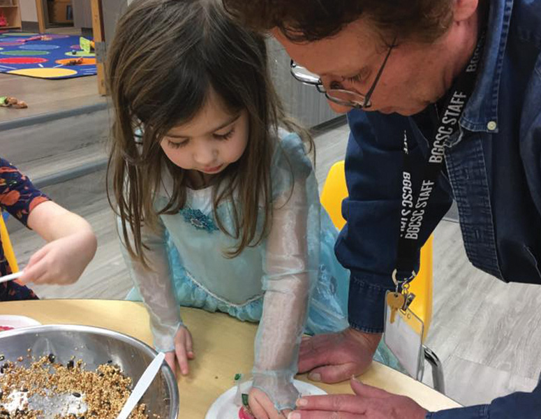 lake_stevens_childcare Lake Stevens staff member helping child make cookies