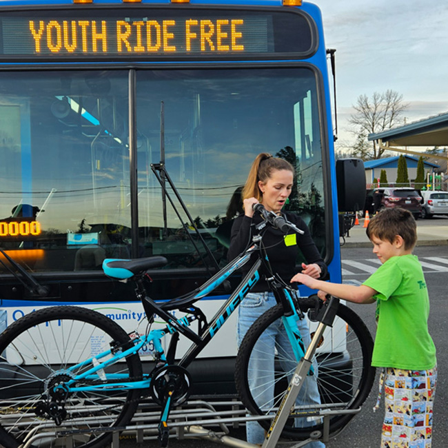 life_skills_650x650 woman showing boy how to use bus bike rack