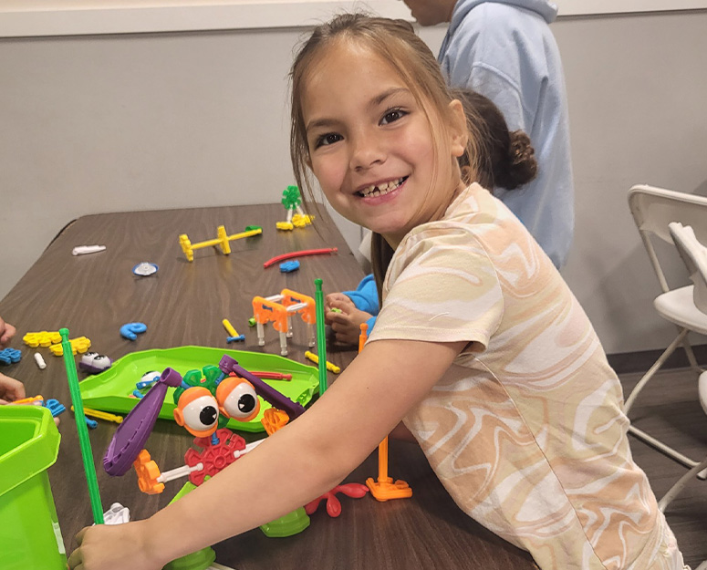 oakharbor_childcare Oak Harbor smiling girl doing arts & crafts project