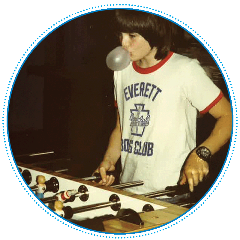 polaroid image of boy playing foosball and chewing gum