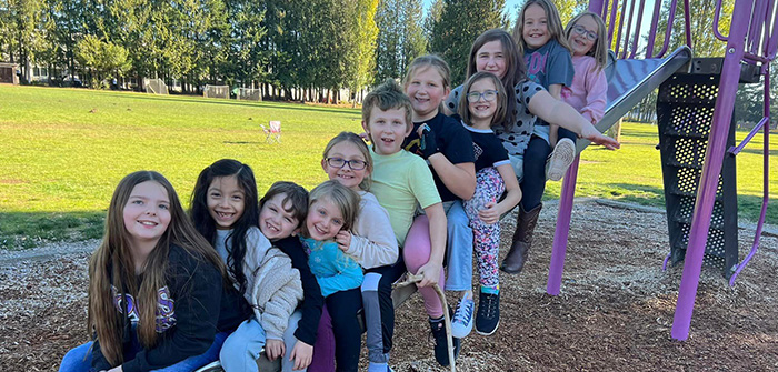 group of kids sitting on a slide