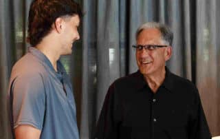 Bill Tsoukalas talking to man