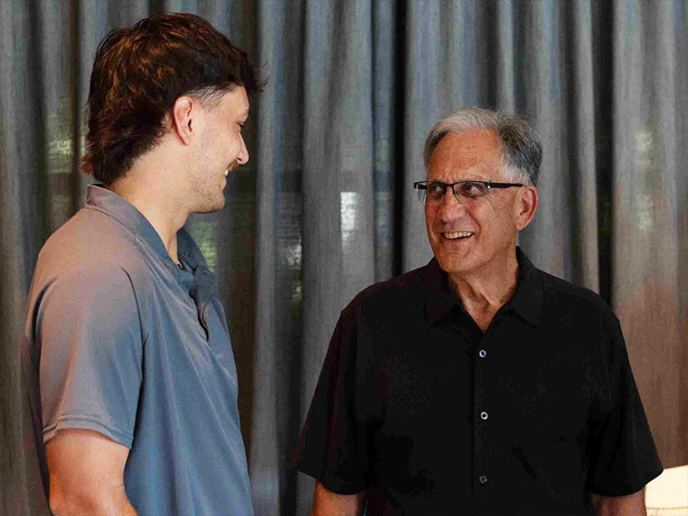 Bill Tsoukalas talking to man