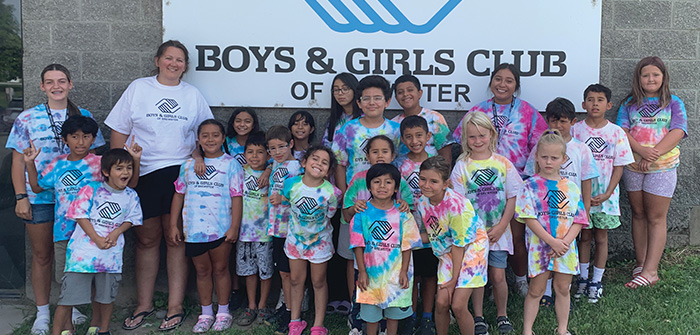 Group of kids standing in front of Boys & Girls Club sign