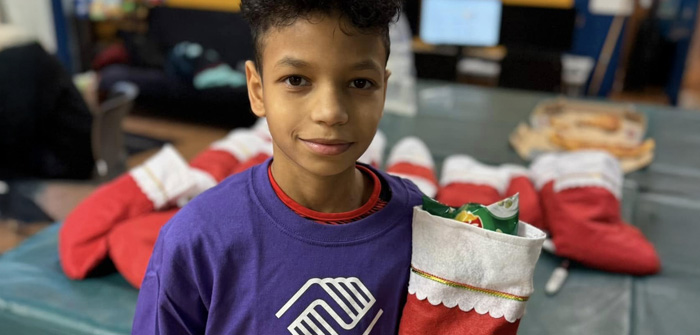 boy holding Christmas stocking