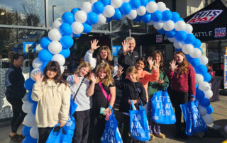 teen girls with shopping bags standing under balloons