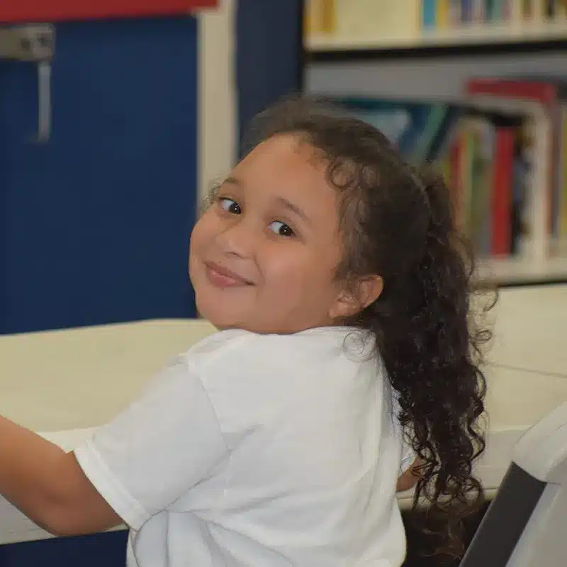 smiling girl looking over shoulder