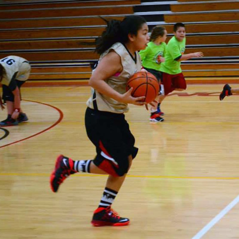 girl running with basketball