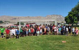 kids posing for picture on soccer field