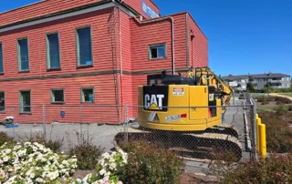 Old brick building with tractor next to it