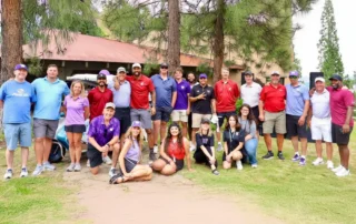 Group of people wearing golfing clothes posing for picture