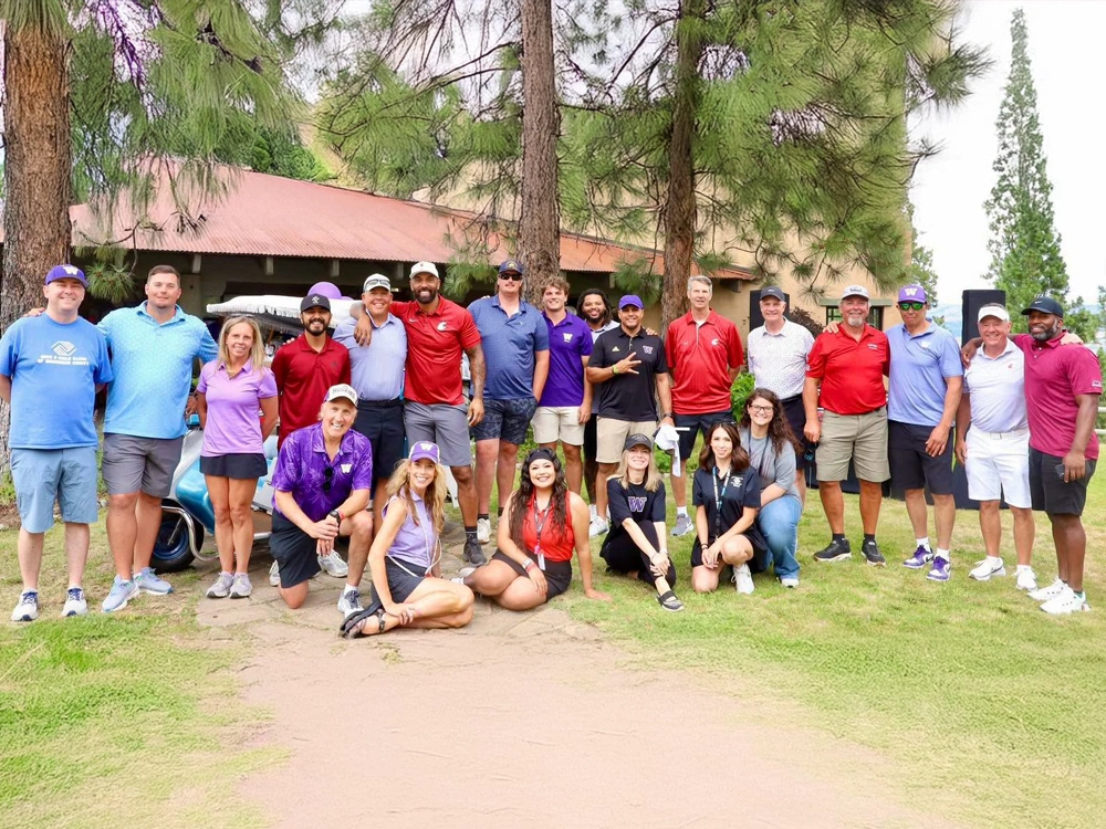 Group of people wearing golfing clothes posing for picture
