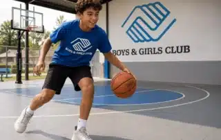 boy playing basketball in covered outdoor sports area